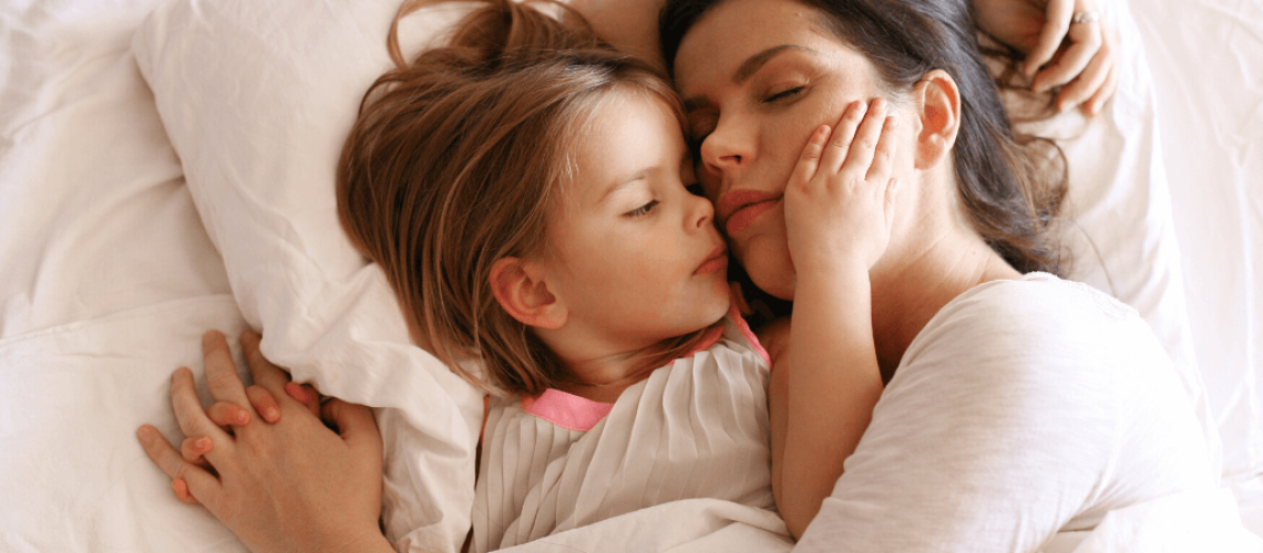 Mother snuggles with daughter